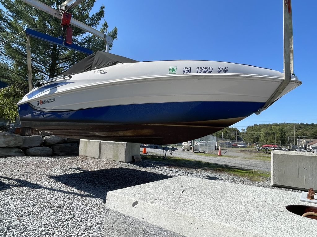 Boat suspended in air after professional washing and detailing at New Wave Marina